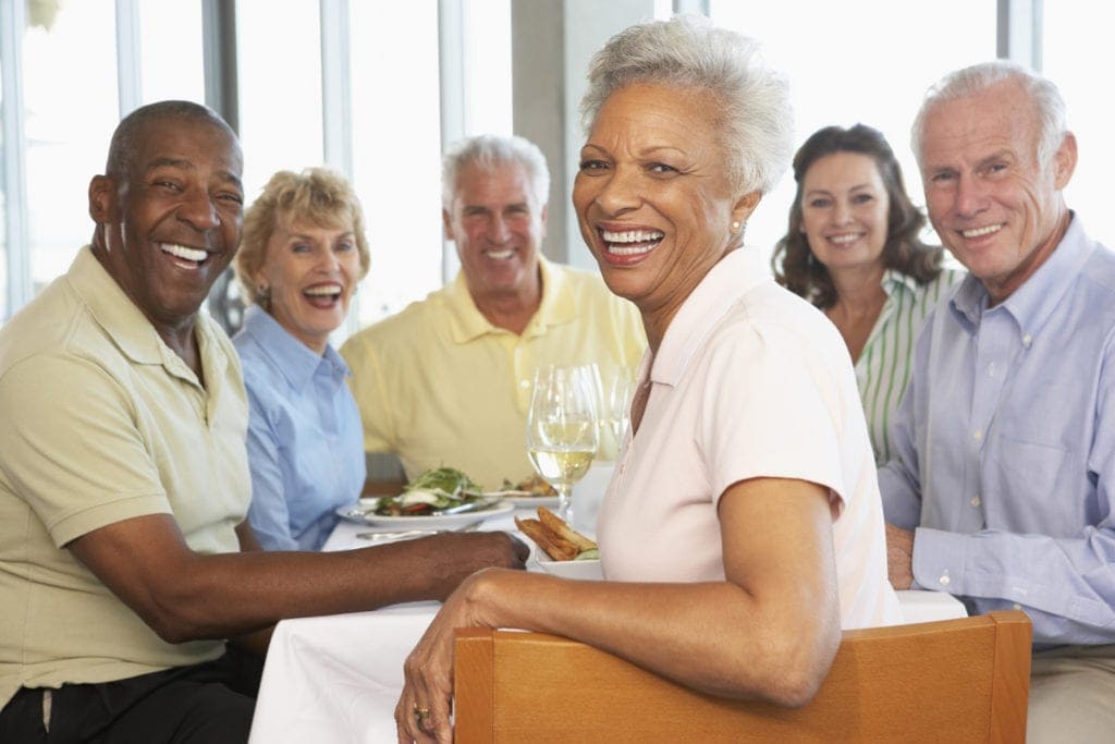 Group of senior friends enjoying lunch together