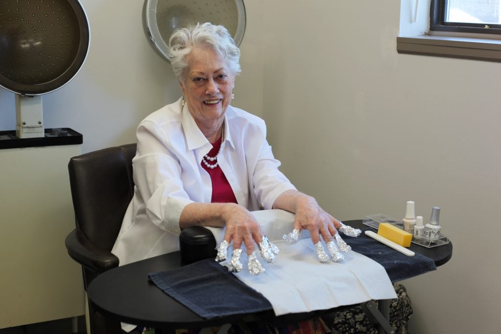 Spa day at the Terrace, a resident is getting her nails done.