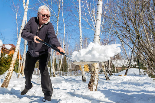 Elderly man shoveling snow