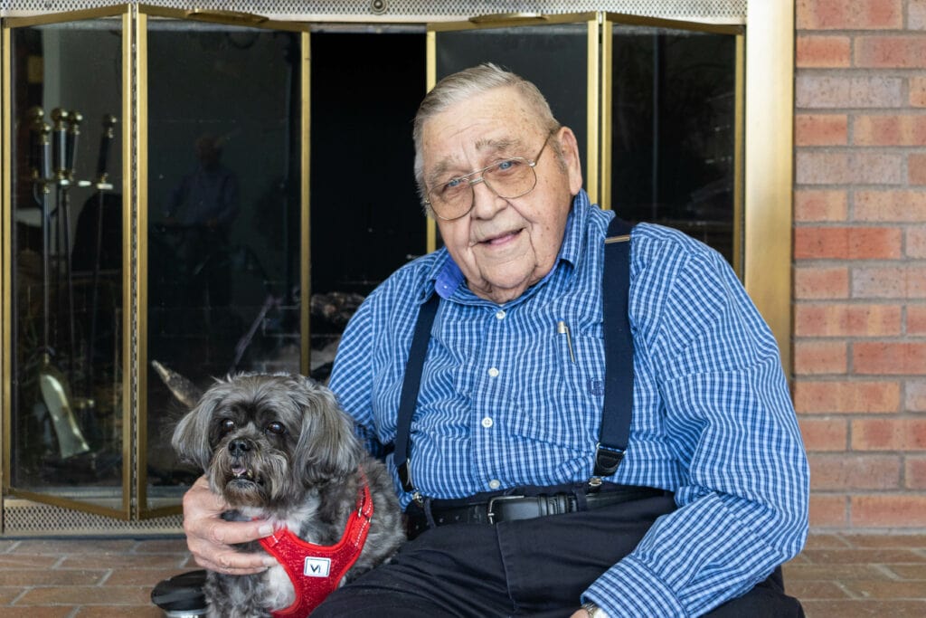 Bob and his dog Bella sitting on the fireplace