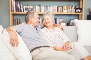Elderly couple sitting in their living room