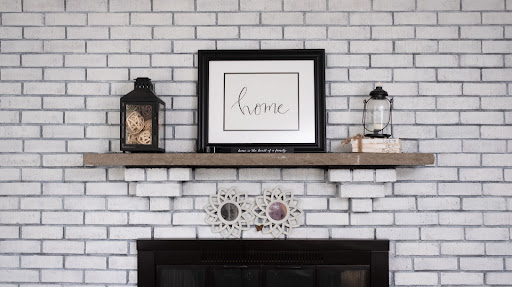 home frame decor against a white brick wall