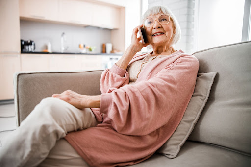 A Senior making a happy phone call