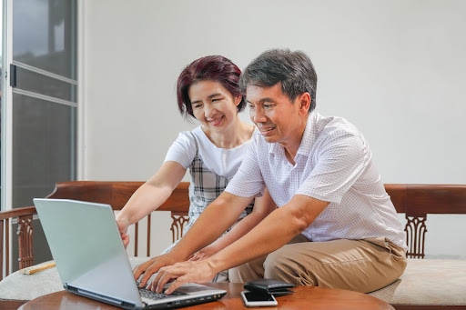 Senior couple having fun on a laptop