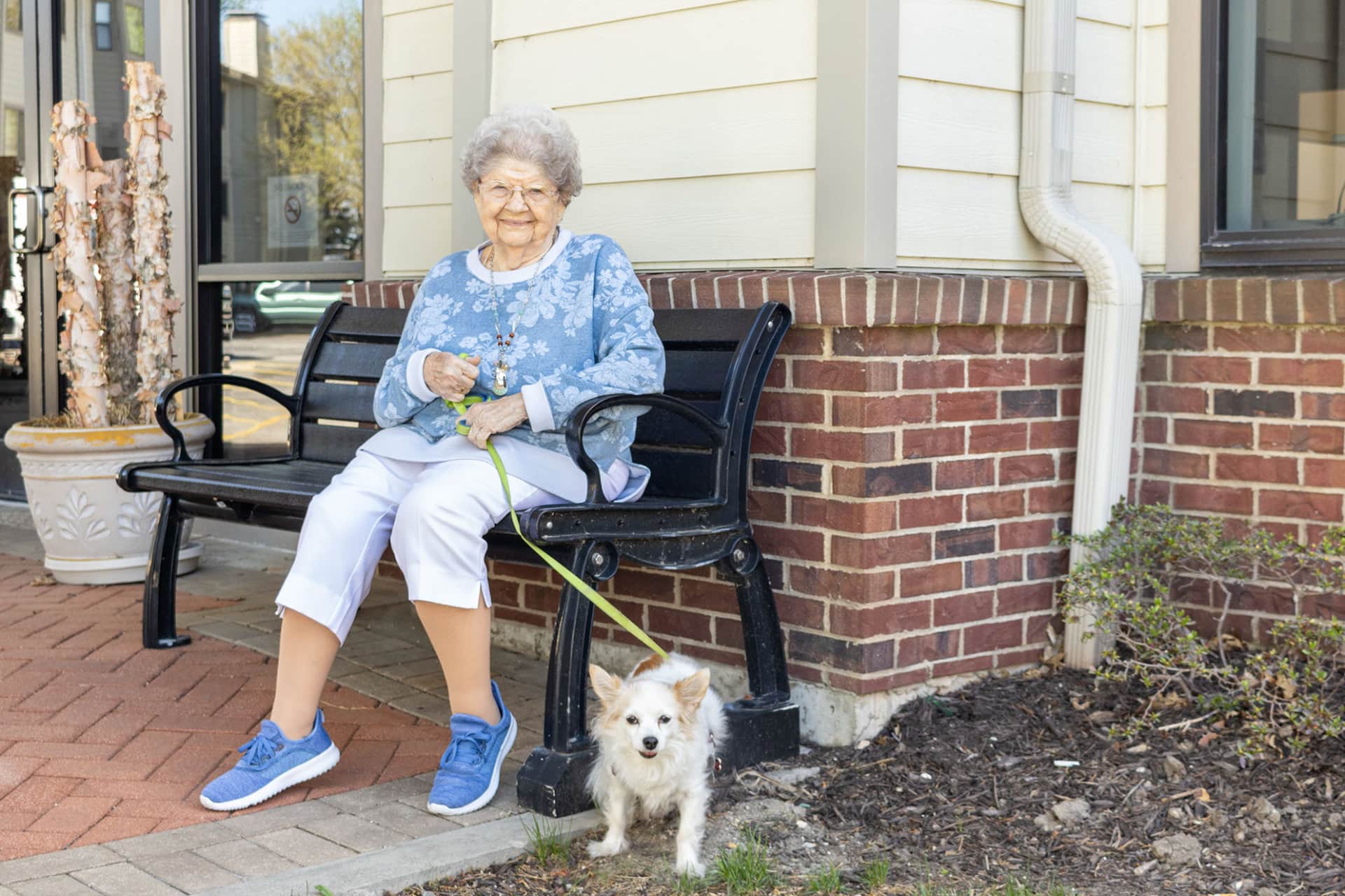 A Terrace residence sitting down on a bench after walking her dog