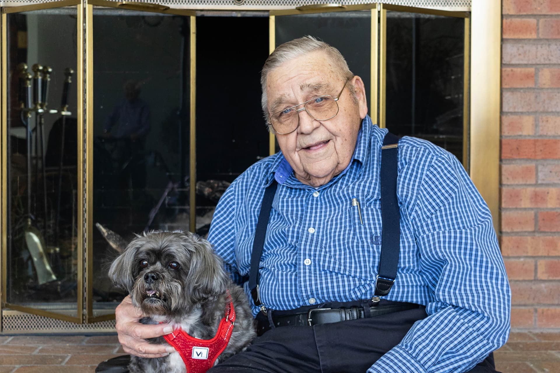 Terrace Retirement senior man sitting with his dog.